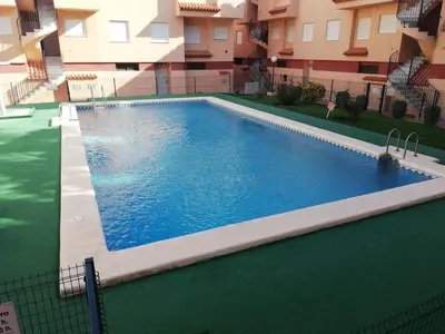 a swimming pool in the middle of a building at Oasis Solo Familias Serviplaya in Casas Las Basas