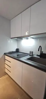 a kitchen with white cabinets and a sink at A7 ViviendaTuristicaValencia Arte in Valencia