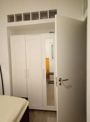 a bedroom with a bed and a white door at Alquilo Habitación individual con aseo privado solo Chicas, only girls in Valencia
