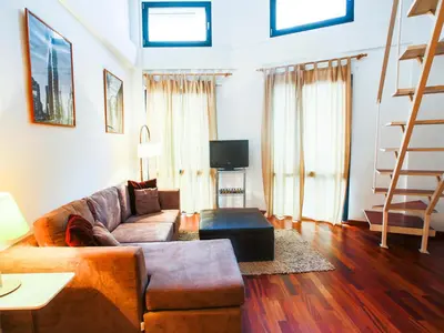 a living room with a couch and a tv at Total Valencia (Leisure & Culture) in Valencia