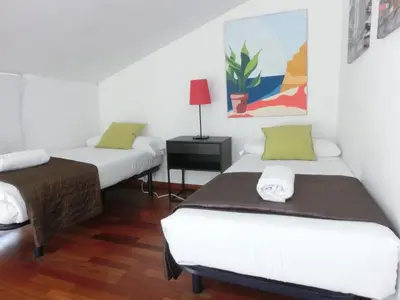 a room with two beds and a table with a lamp at Total Valencia (Leisure & Culture) in Valencia