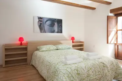a bedroom with a bed and a painting on the wall at Singular Apartments Station in Valencia