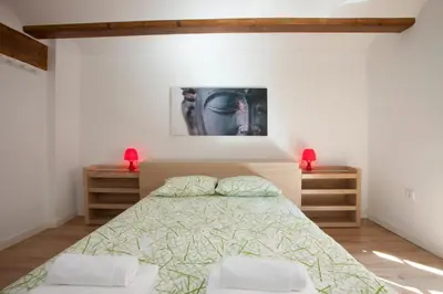 a bedroom with a bed and a painting on the wall at Singular Apartments Station in Valencia