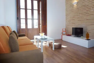 a living room with a couch and a tv at Singular Apartments Station in Valencia