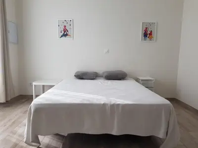 a white bedroom with a bed with two pillows on it at Studio Picasso near the port and beach in Valencia