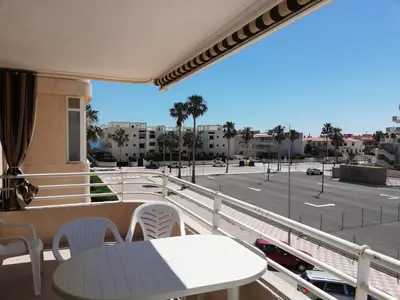 a balcony with a table and a view of a street at Las Olas Solo Familias Serviplaya in Casas Las Basas