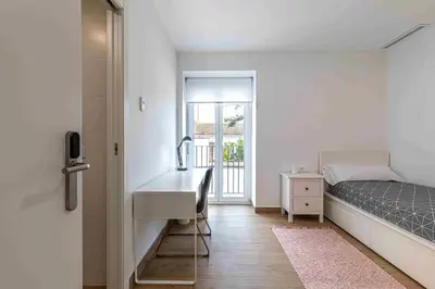 a small bedroom with a sink and a bed at Residencia Demar in Godella
