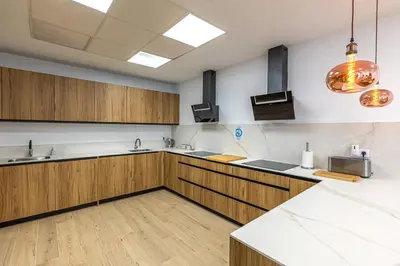 a large kitchen with wooden cabinets and counters at Residencia Demar in Godella