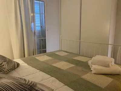 a bedroom with a bed with a large mirror at Alojamiento en Losa del Obispo in Losa del Obispo