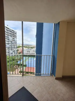 a room with a balcony with a view of the water at Precioso apartamento residencial con vistas al mar in Puebla de Farnals