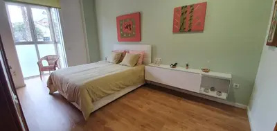 a bedroom with a bed and a desk and a window at Sunny&Beach in Valencia in Valencia