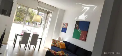 a living room with a couch and a dining room table at Sunny&Beach in Valencia in Valencia