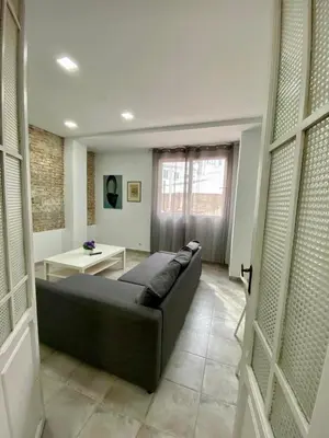 a living room with a couch and a table at Ruzafa Vibes Apartments in Valencia