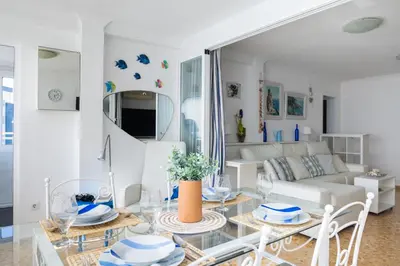 a living room with a table and a couch at Platja Puig in Valencia