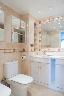 a bathroom with a toilet and a sink and a mirror at Platja Puig in Valencia