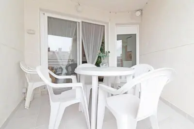 a small bedroom with a bed and a white cabinet at Global Vacacional, Increíble apartamento en la playa, Canet d'en Berenguer in Canet de Berenguer