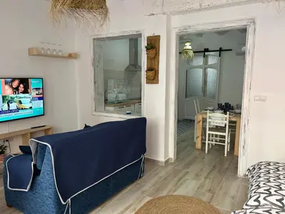 a living room with a blue couch and a table at Alzira bonita Loft A junto plaza mayor, la Murta in Alzira