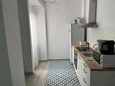 a kitchen with a refrigerator and a counter top at Alzira bonita Apartamento B con patio, la Casella in Alzira