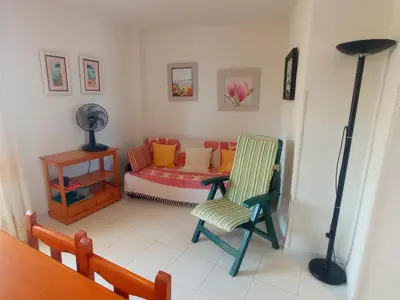 a living room with a chair and a couch at Les Motes Solo Familias Serviplaya!!! in Playa de Xeraco