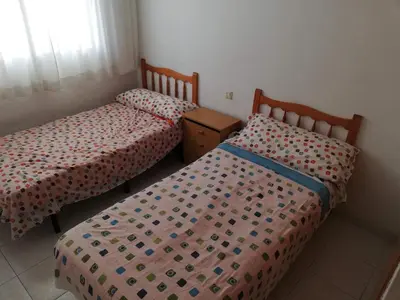 two beds in a small room with at Les Motes Solo Familias Serviplaya!!! in Playa de Xeraco