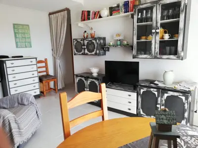 a living room with a tv and a table at Les Motes Solo Familias Serviplaya!!! in Playa de Xeraco
