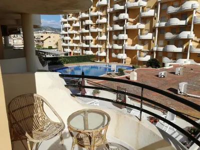 a balcony of a hotel with chairs and a swimming pool at Les Motes Solo Familias Serviplaya!!! in Playa de Xeraco