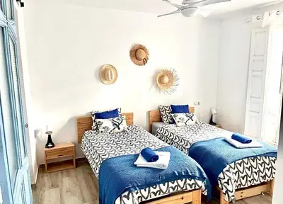 two beds in a room with blue and white at Alzira bonita Apartamento D junto a Plaza Mayor, Santa Catalina in Alzira