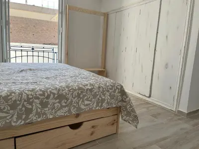 a bedroom with a bed and a large window at Alzira bonita Apartamento D junto a Plaza Mayor, Santa Catalina in Alzira