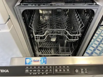 an open dishwasher with its door open with its racks at Alzira bonita Ático E Plaza Mayor con gran terraza in Alzira