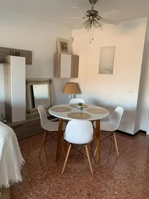 a dining room table and chairs in a room at Pobla-Mar in Valencia