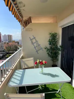 a white table on a balcony with flowers on it at Pobla-Mar in Valencia