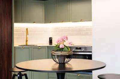 a kitchen with a table with a vase of flowers on it at Encantador Loft a un Paso del Río Turia in Valencia