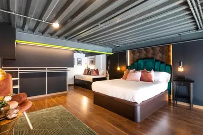 a bedroom with a bed and a couch in a room at Encantador Loft a un Paso del Río Turia in Valencia
