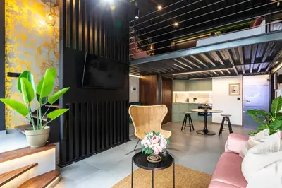 a living room with a couch and a tv at Encantador Loft a un Paso del Río Turia in Valencia