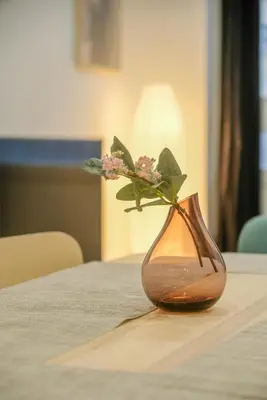 a vase with a flower in it sitting on a table at Apartment with Open-air Space in Valencia