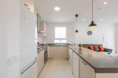 a kitchen with white cabinets and a counter top at Spacious Penthouse with Private Terrace in Valencia