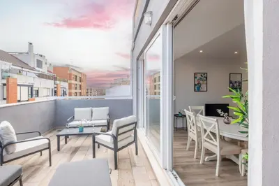 a room with a balcony with a table and chairs at Spacious Penthouse with Private Terrace in Valencia