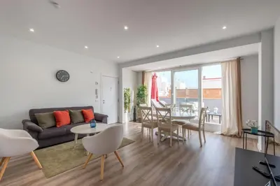 a living room with a couch and a table and chairs at Spacious Penthouse with Private Terrace in Valencia