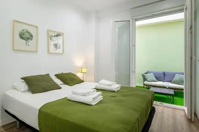 a bedroom with a large bed with towels on it at Apt with Fluffy Beds & Private Patio in Valencia