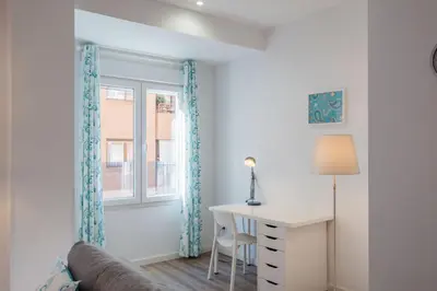 a living room with a desk and a window at Spacious & Clean Apartment in Quiet Area in Valencia