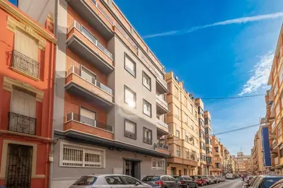 a city street with cars parked in front of buildings at Spacious & Clean Apartment in Quiet Area in Valencia