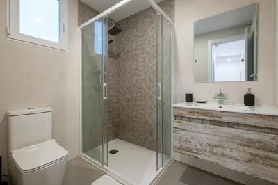 a bathroom with a shower and a toilet and a sink at Spacious Clean & Colorful Apt Quiet Zone in Valencia