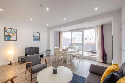 a living room with a couch and a table at Modern Penthouse with Private Terrace in Valencia