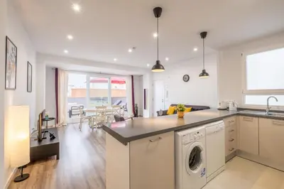 a kitchen and living room with a washing machine at Modern Penthouse with Private Terrace in Valencia