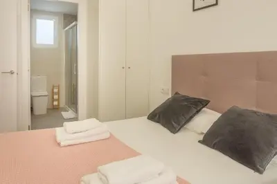 a bedroom with a bed with two towels on it at Modern Penthouse with Private Terrace in Valencia
