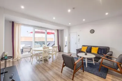a living room with a couch and a table at Modern Penthouse with Private Terrace in Valencia