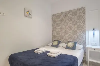 a bedroom with a blue bed with towels on it at Sunny,Private Terrace,Wheelchair access in Valencia
