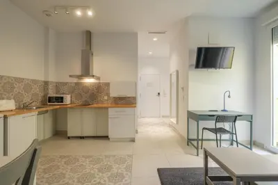 a kitchen with white cabinets and a blue table at Sunny,Private Terrace,Wheelchair access in Valencia