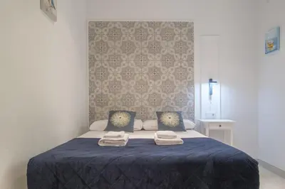a bedroom with a blue bed with two towels on it at Sunny,Private Terrace,Wheelchair access in Valencia