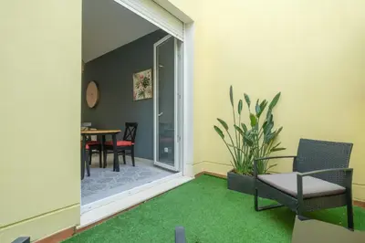 a living room with a green rug and chairs and a table at Chic & Comfortable Apartment, Private Terrace in Valencia
